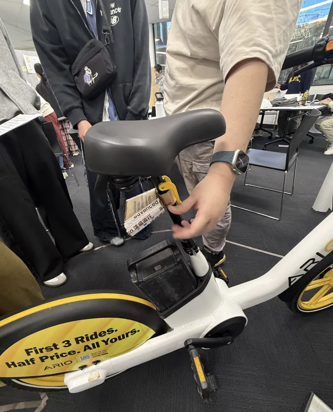 A participant fitting the laser device under the saddle of a bike